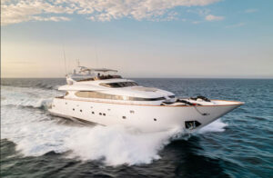 Luxury Yacht Sailing Through the Ocean A stunning luxury yacht gliding through the ocean, leaving a trail of waves behind. The yacht features an elegant design with a sleek white exterior, perfect for an upscale cruising experience. The sunlit sky and calm waters enhance the sense of luxury and adventure on the high seas.