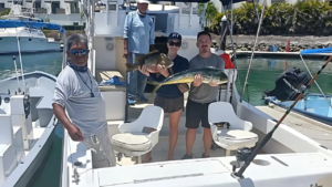 Fishing in Cabo San Lucas Mexico – Happy Anglers with Their Catch Couple on a charter boat holding fresh catches, illustrating fishing in Cabo San Lucas Mexico